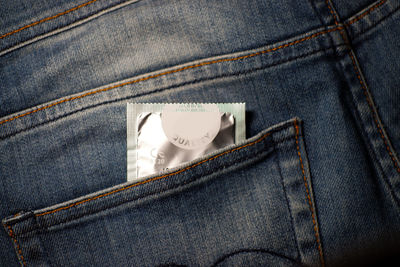 Close-up of condom packet in jeans pocket