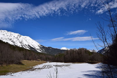 Scenic view of snow covered mountains against sky