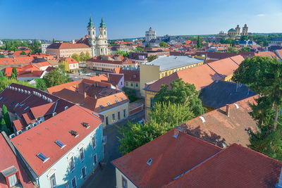 High angle view of town against blue sky