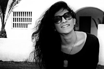 Portrait of smiling young woman in sunglasses