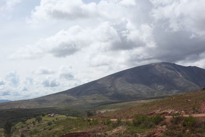 Scenic view of mountains against cloudy sky
