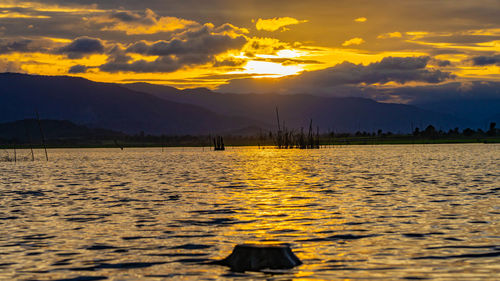 Scenic view of lake against sky during sunset