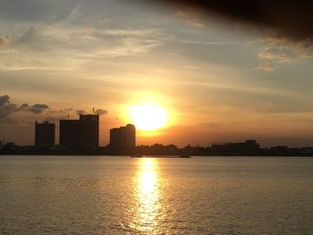 Scenic view of silhouette buildings against sky during sunset