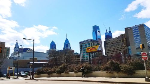 Buildings in city against blue sky