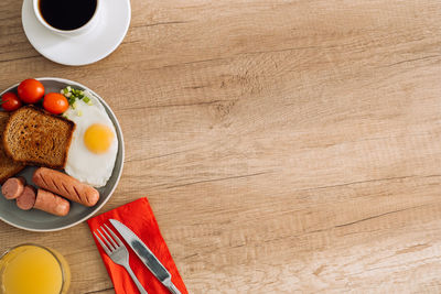 English breakfast with black coffee and orange juice on the wooden table with copy space	
