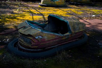 High angle view of abandoned car on field