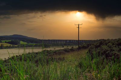 Scenic view of field against sky during sunset