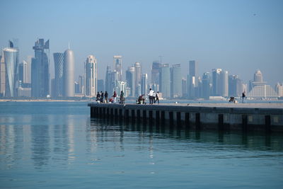 Panoramic view of sea and buildings against sky