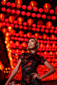 Low angle view of woman with illuminated lantern