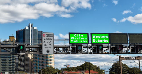 Low angle view of information sign against buildings in city