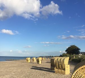 View of calm beach against blue sky