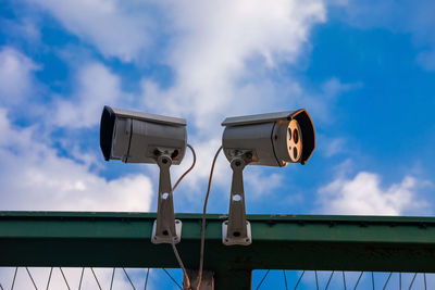 Low angle view of telephone pole against sky