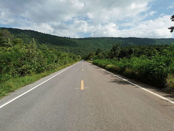 Empty road along countryside landscape