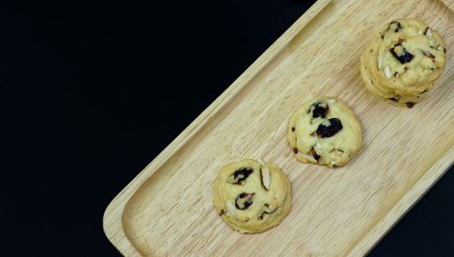 High angle view of cookies on table against black background