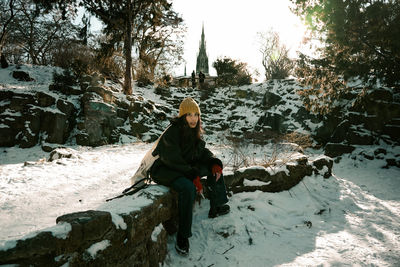 Woman on snow covered trees