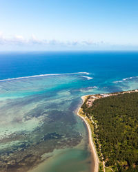 Wind surfers, turquoise ocean, and coral reefs from high angle view in le morne beach, mauritius