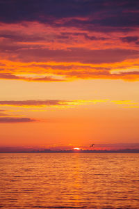 Scenic view of sea against orange sky