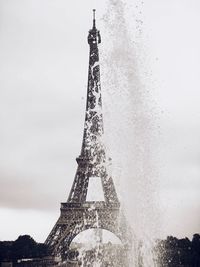 Low angle view of tower against cloudy sky