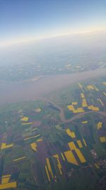 Aerial view of agricultural field against sky