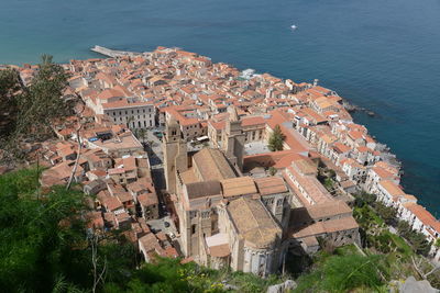 High angle view of townscape by sea