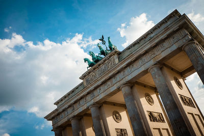 Low angle view of historical building against cloudy sky