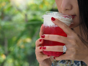 Midsection of woman drinking glass