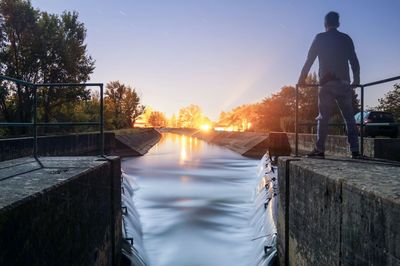 Reflection of people on pier in sea