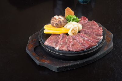 High angle view of food in plate on black background