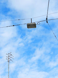 Low angle view of electricity pylon against sky