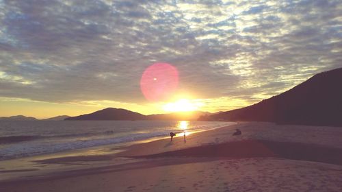 Scenic view of beach against sky during sunset