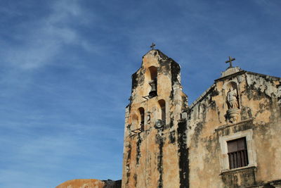 Low angle view of old building against blue sky