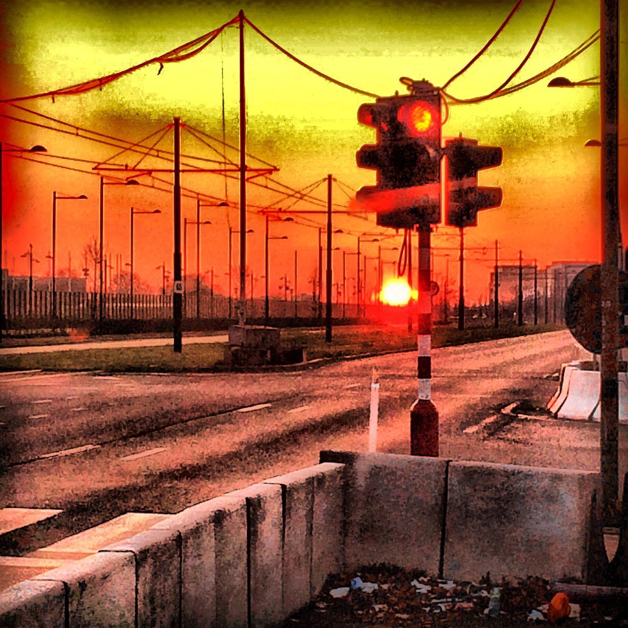 sunset, transportation, orange color, sky, sun, railroad track, street light, sunlight, connection, road, rail transportation, outdoors, fence, built structure, no people, landscape, red, electricity pylon, architecture, mode of transport