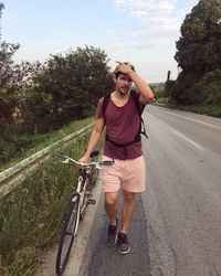 Portrait of man riding bicycle on road