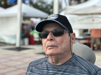 Close-up of man wearing cap and sunglasses