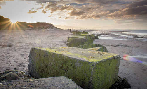 Scenic view of beach against sky during sunset