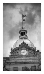 Low angle view of building against cloudy sky