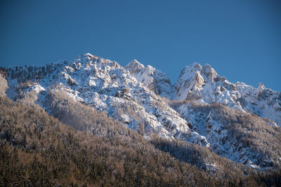 Scenic view of snowcapped mountains against clear blue sky