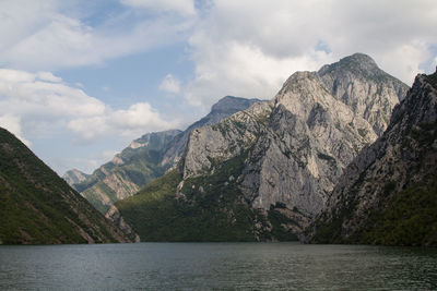 Scenic view of sea and mountains against sky