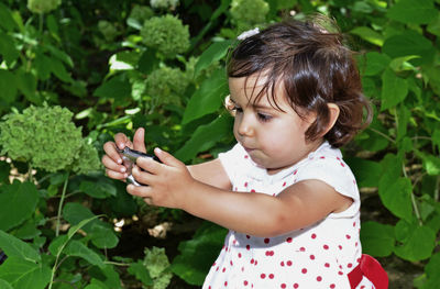 Close-up of cute girl holding plant