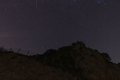 Low angle view of mountain against sky at night