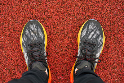 Low section of man standing on sand