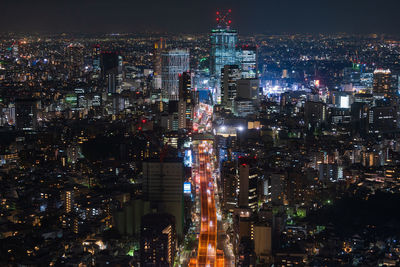 High angle view of illuminated buildings in city at night