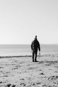 Full length of man on beach against clear sky
