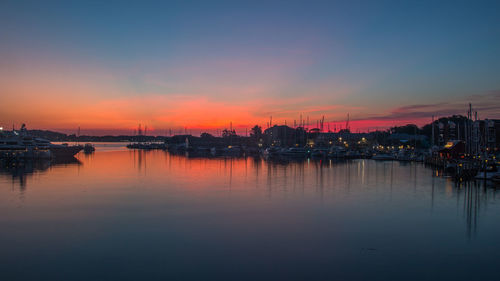 Sailboats in marina at sunset