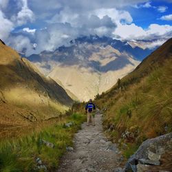 Rear view of woman standing on mountain landscape