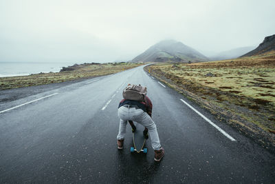 Man skateboarding on highway