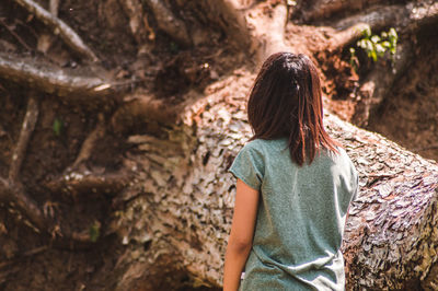 Rear view of woman standing on rock