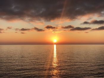 Scenic view of sea against romantic sky at sunset