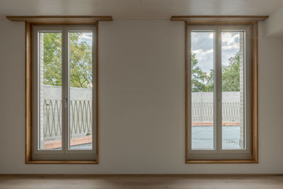 Trees seen through window of house