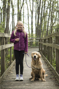 Full length of girl with dog